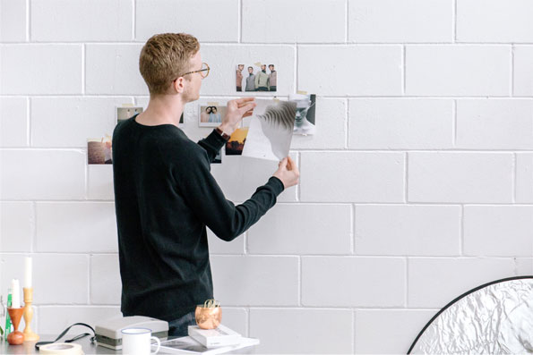 boy putting pictures on the wall